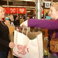 Erin Folcher, a cashier at Old Navy in Rogers, helps customer Tiffany Tayrien on Tuesday with her pu...