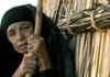 An 83-year-old displaced Iraqi woman stands outside her shelter Tuesday in a makeshift village, Um Khashim, outside Najaf. About 200 families with no other place to go live in the village.