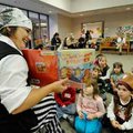 Erin Mink, children’s assistant, reads “The No-Good Do-Good Pirates” book to children Tuesday at the...
