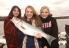 Cassidy Kendrick, center, caught the first fish of her life Tuesday, a nice-sized striper, during the Springdale Central Junior High School fishing club’s annual outing on Beaver Lake. With Kendrick are club members Mariella Camposeo, left, and Megan Hanson. 
