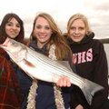 Cassidy Kendrick, center, caught the first fish of her life Tuesday, a nice-sized striper, during th...
