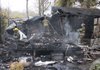 Firefighters spray hot spots Tuesday morning on the remains of the mobile home belonging to E.J. and Flora Cato at 13411 Mobile Drive in southern Pulaski County.
