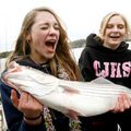 Springdale Central Junior High ninth-graders Cassidy Kendrick (left) and Megan Hanson, both 14, reac...