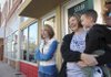 Jolana Gooding, left, and Stacy Wharry, holding Silas Gooding, 2, talk Wednesday in downtown Bentonville about their plans for shopping Friday. 