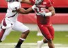 Arkansas tailback Dennis Johnson stiff-arms Mississippi State’s Robert Elliott on a kickoff return during the Razorbacks’ game Saturday in War Memorial Stadium in Little Rock.
