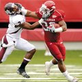 Arkansas tailback Dennis Johnson stiff-arms Mississippi State’s Robert Elliott on a kickoff return d...