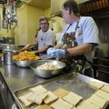 Mark Foster, left, and David Elliott work on sweet potato casserole and dressing Wednesday while pre...