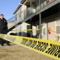 John Brashear with the Rogers Police Department puts up crime scene tape around an apartment Wednesd...