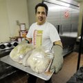 Matt Silano brings a plate of turkeys to the oven Wednesday at the Salvation Army in Springdale in p...