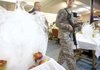 A soldier carries his Thanksgiving Day lunch Thursday at the U.S. base in Bagram, Afghanistan.