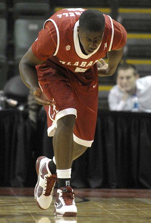 Alabama’s Tony Mitchell (above) staggers down the court after receiving a gash above his eye during the second half of the Crimson Tide’s 79-76 victory over Baylor on Wednesday at the Old Spice Classic in Lake Buena Vista, Fla.