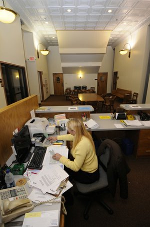Annette Jarnagan, customer service representative at the Fayetteville water department, works Tuesday in the recently remodeled portion of City Hall. Fayetteville city services such as human resources or parking have been placed on the first floor of City Hall. The remodel is designed improve circulation and cluster resident services in one location.