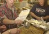 Becky Brady, left, and Burgerland owner Doris Spindler dish up one of 500 free Thanksgiving dinners given away at the restaurant in Lincoln on Thursday.