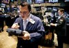 Michael Zicchinolfi of the Livermore Trading Group works Friday on the floor of the New York Stock Exchange.