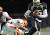 Shiloh Christian quarterback Kiehl Frazier, right, reaches to fend off Nashville defensive back Erin Adams during the second quarter of Friday’s Class 4A playoff game in Champions Stadium in Springdale.


