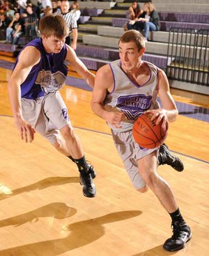 Fayetteville senior forward Adam Noble, right, drives along the baseline past Colton Primm during the Dogs’ Purple-White game Nov. 12 at Fayetteville High. 