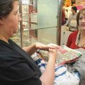 Stephanie Gage, right, with Kohl’s, shows Ophelia Sikes jewelry Friday at the Rogers store.
