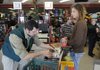 Shane Smith, right, purchases DVDs from employee John McEuen, left, as he Christmas shops Friday at Hastings Books, Music and Video in Springdale.