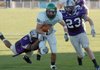 Central Arkansas defenders Jamie Hill (left) and James Lancaster (right) attempt to bring down North Dakota quarterback Jake Landry on Saturday at Estes Stadium in Conway.