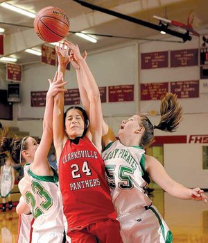 Clarksville guard Serena Clokey, center, reaches for a rebound as Greenland guard Zoe Seay, left, and junior post Andrea Scott defend during the first half of Saturday’s game in the Farmington Lady Cardinal Classic at Farmington High.
