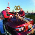 Mitch Church of Fayetteville, left, and Bill Lamphear of Gentry affix a motorized wind-up key Saturd...