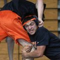Rogers Heritage’s Wilfredo Serrano, right, shoots for a takedown Friday during practice in Rogers.