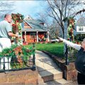 Bill and Carol Eaton work Saturday to decorate their Fayetteville home along East Lafayette Street i...