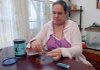 Layla Amussen rolls her own cigarette in her Little Rock home on Friday. She said she can save about $50 a month by not buying packaged cigarettes.
