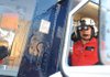 Tim Collins, a flight medic with Air Evac Lifeteam in Springdale, demonstrates Saturday the new night vision goggles the crew uses to navigate to emergency scenes. The goggles attach to the flight helmet and are used to navigate in darkness.
