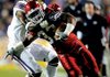 Arkansas tailback Dennis Johnson is tackled by LSU cornerback Patrick Peterson at the end of a big gain on the opening drive of the Razorbacks’ game Saturday in Tiger Stadium in Baton Rouge, La.
