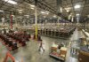 A warehouse worker walks past pallet jacks at an Amazon.com warehouse on Nov. 16.