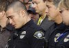A Lakewood, Wash., police officer tears up during a news conference Monday on Sunday’s fatal shooting of four Lakewood officers at a coffee shop. A murder warrant has been issued for former Arkansas resident Maurice Clemmons, 37, who was the subject of an intense manhunt Monday.