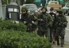 Law officials in Parkland, Wash., search an area near a coffeehouse where four police officers were fatally shot Sunday in what was called a targeted ambush.