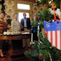 Beverley Garside, left, of the Rogers Historical Museum gives a tour of “A World War I Christmas” in...