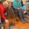 Jack and Melba Decker’s dog, Harvey, gets a dog treat from Bobbie Aldridge in their home in Bentonvi...