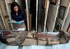 Working with a team of curators, Laura Shafer checks the condition of a female mummy in August soon after its arrival in Little Rock for the Arkansas Arts Center’s “World of the Pharaohs” exhibit. 