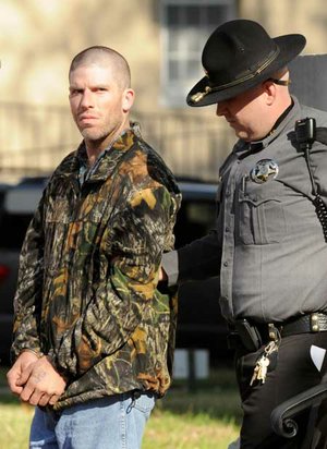 A Benton County Sheriff’s deputy escorts a handcuffed Willie Blackston to a prisoner transport vehicle Monday in Bentonville after Blackston pleaded guilty to second-degree murder. Blackston was charged with causing injuries that resulted in the death of Miguel Barron on Jan. 5, 2008.
