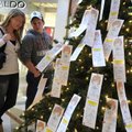 Sarah Ewart, left, and Matthew Alsop, both of Siloam Springs, look at the Salvation Army Angel Tree ...