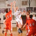 Bentonville Gold’s Austin Haggard shoots in the lane over Gravette’s Alex Lovell during the second h...
