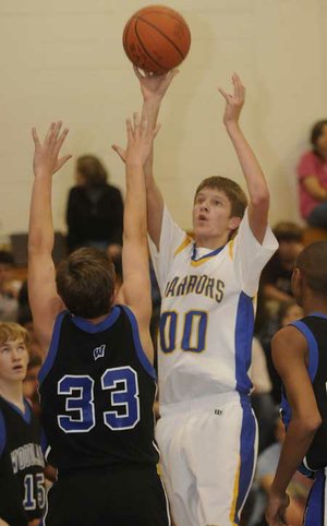 Central’s Alex Rice, left, takes a shot over Woodland’s Chase Carney during Monday’s game in Springdale.