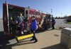 Christine Milmore of Springdale, left, is helped onto an Ozark Regional Transit bus by ORT driver John Gladwell on Monday at Walmart Supercenter on South Thompson Street in Springdale. The system is adding service on Saturdays for its paratransit riders. 