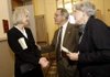 Kim Harington (left), widow of novelist Donald Harington, talks with Eddie Bradford and his wife, Betty, both of Fayetteville, on Monday after a memorial service for Donald Harington at Giffels Auditorium at the University of Arkansas at Fayetteville.