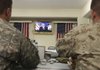 U.S. soldiers listen to President Barack Obama's speech on TV at the U.S. Camp Eggers in Kabul, Afghanistan on Wednesday.