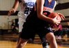 Rogers Heritage’s Ashley Ward, right, grabs a rebound in front of Rogers’ Taylor Strickland during Tuesday’s game in the Benton County Invitational Tournament in Siloam Springs.