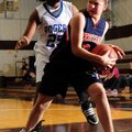 Rogers Heritage’s Ashley Ward, right, grabs a rebound in front of Rogers’ Taylor Strickland during T...