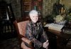 Leah Whitehead, executive director of the Peel Mansion, sits Monday in the study at the mansion in Bentonville.