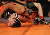 Rogers Heritage’s Peter Rameriz, top, works on pinning Van Buren’s Christian Hesslen during Tuesday’s dual meet in Rogers. Rameriz won his match with a pin.
