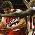 Arkansas forward Michael Sanchez, left, drives to the basket as Oklahoma guard Willie Warren defends...