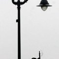 Sergio Jacobo with the Bentonville Electrical Utilities Department installs a new head on a lamp pos...