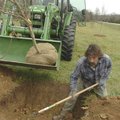 DeWayne Barnes levels a hole during a tree-planting project Wednesday at Pea Ridge National Military...